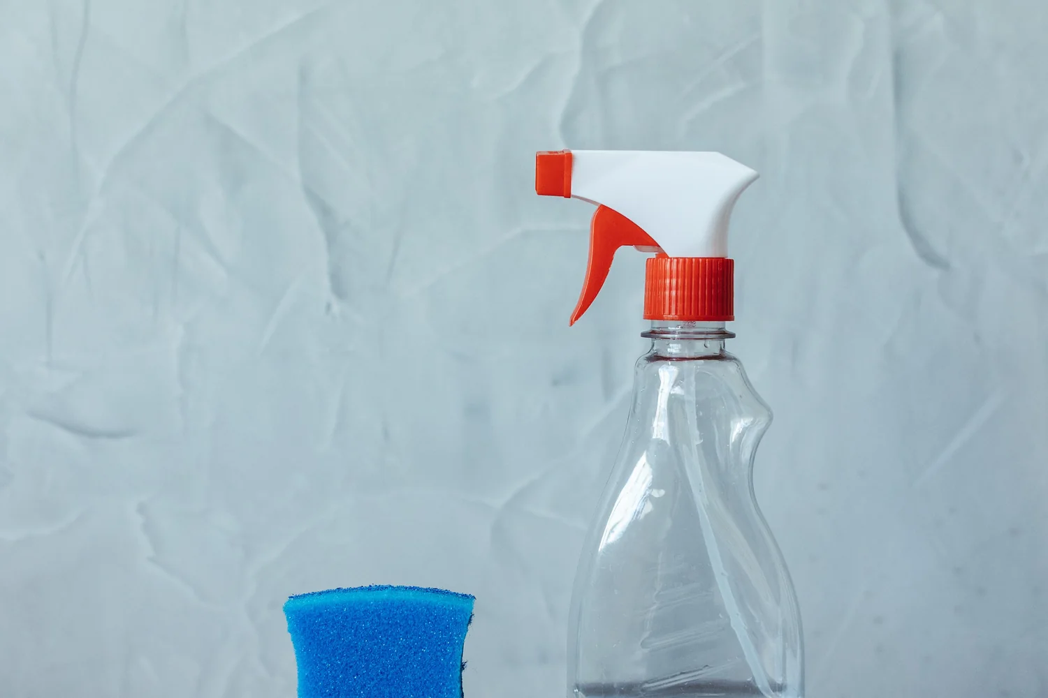 Generic cleaning products and home care tools in a tidy scene.