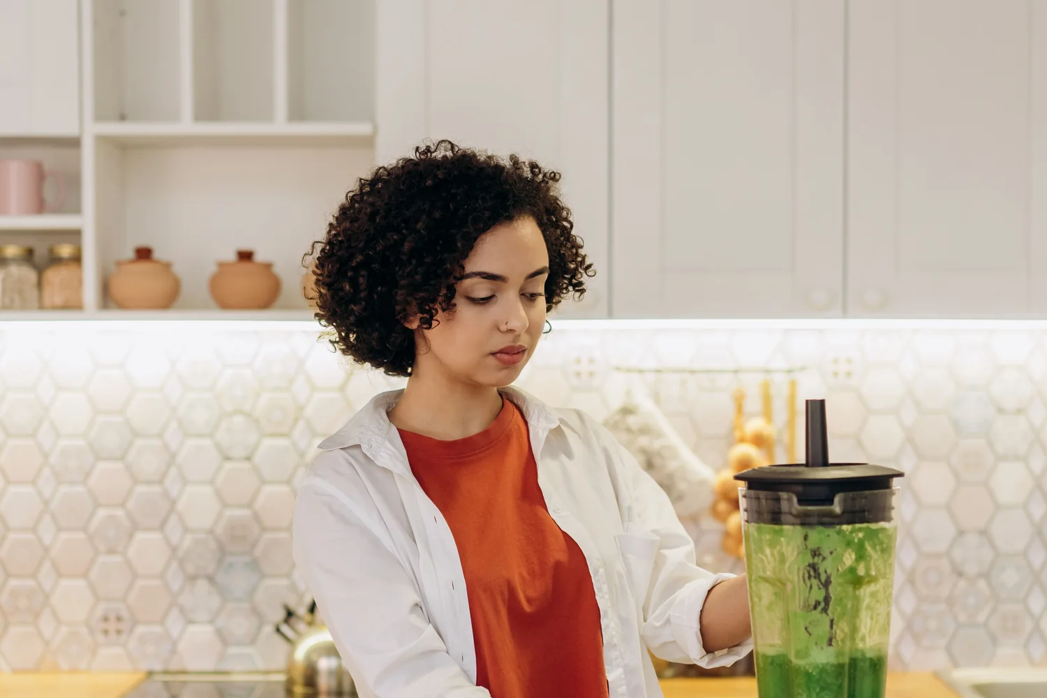 Small kitchen appliances arranged on a well-lit countertop.